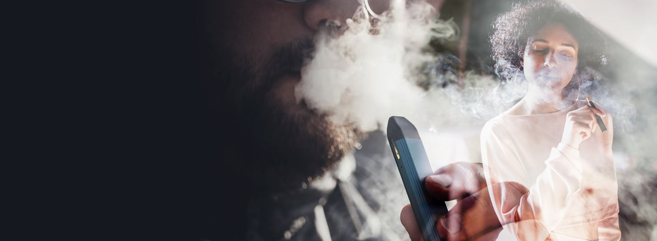 Two people using vaping devices with visible smoke in an urban setting.