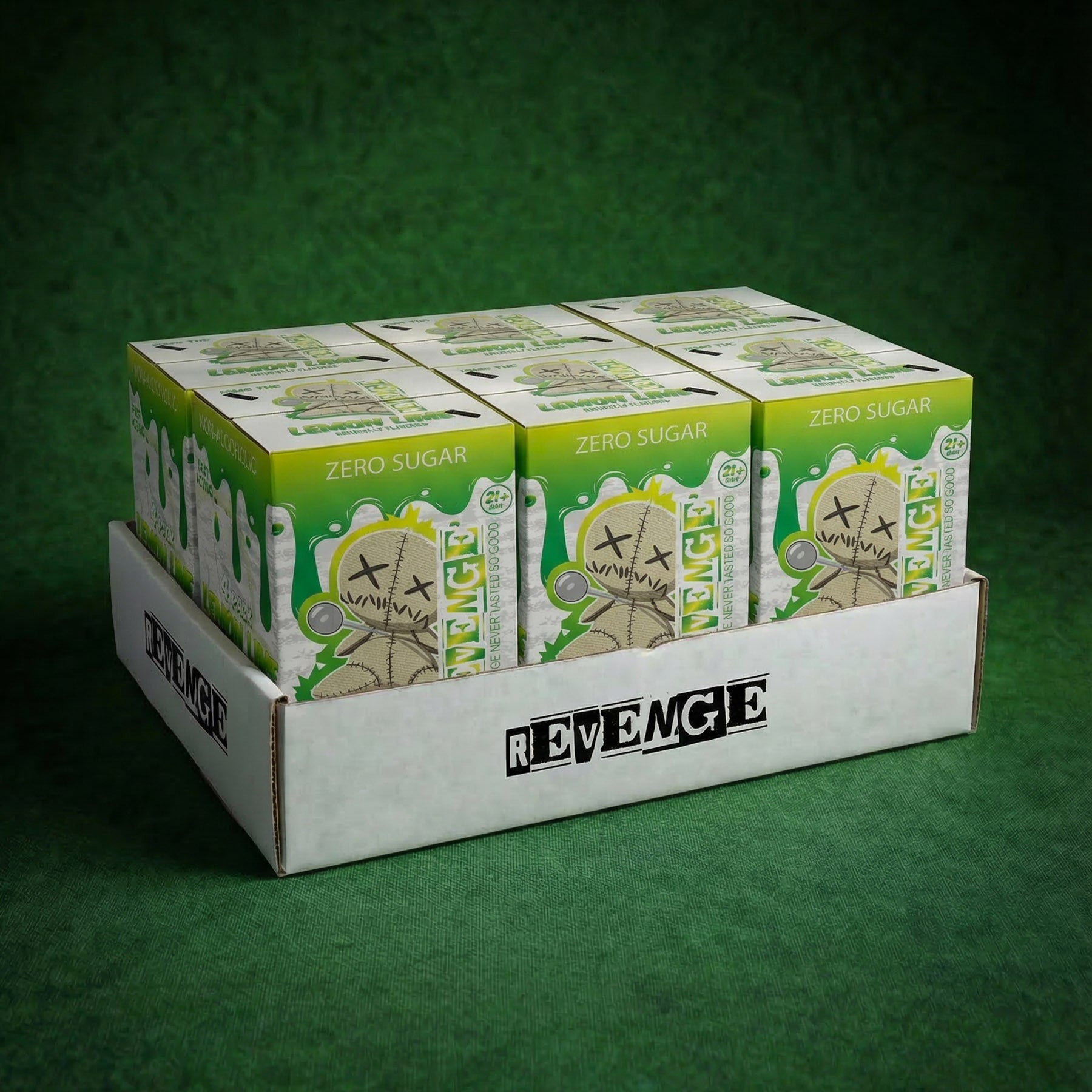 Display of Revenge energy drink boxes on a green background